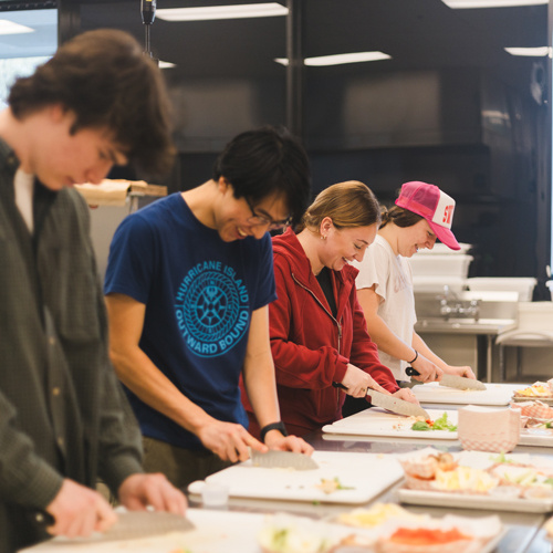 students smiling in a cooking class