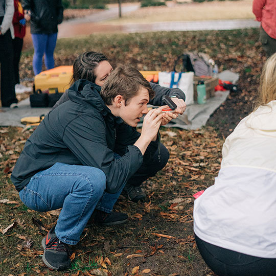 student holding a camera