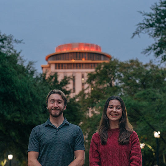 students standing in front of a tall building