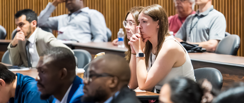 Students in lecture hall looking focused