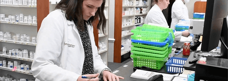garnet bar with image of pharmacist in community pharmacy