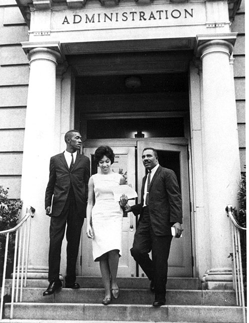 Teenage Henrie Monteith crosses campus flanked by fellow incoming students Robert Anderson (left) and James Solomon Jr. on her way to register for classes, Sept. 11, 1963